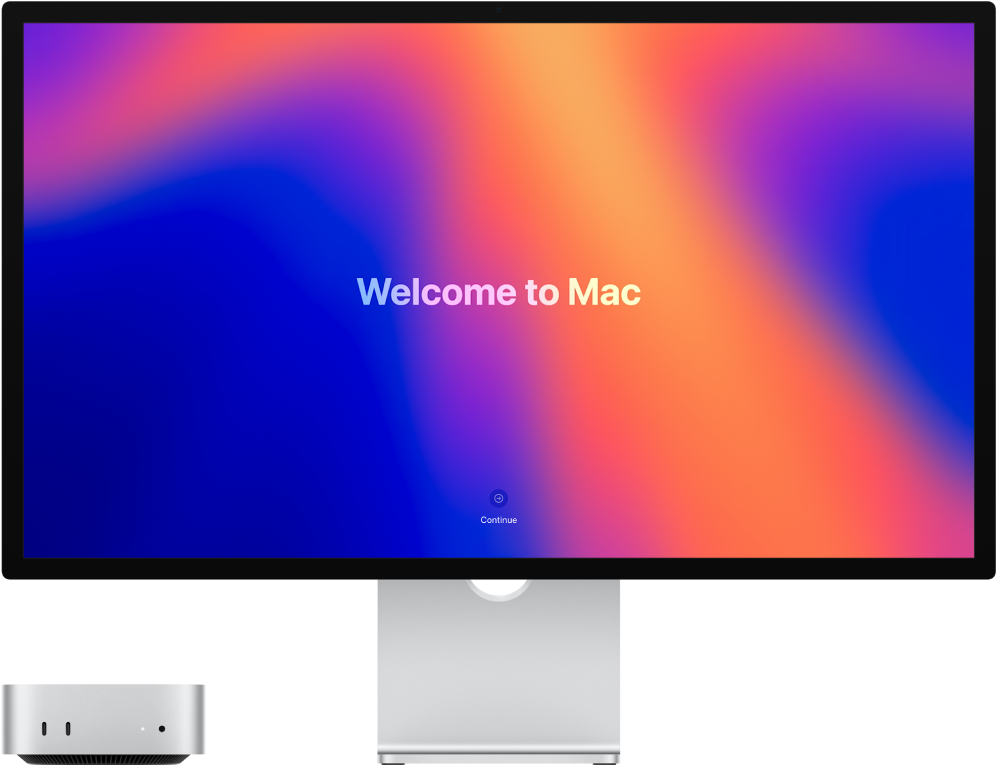 Una pantalla Studio Display con un Mac mini al lado y la palabra “Te damos la bienvenida al Mac” en la pantalla.