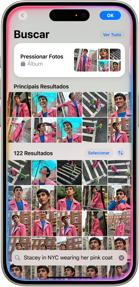 Um iPhone mostrando fotos no app Fotos. Uma barra de busca com uma descrição aparece na parte inferior da tela.
